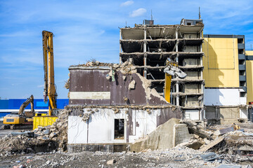 Fototapeta premium Building House destruction Demolition site Excavator with hydraulic crusher machine ruin house