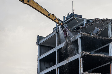 Building House destruction Demolition site Excavator with hydraulic crusher machine ruin house