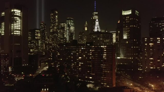 AERIAL: Towards Manhattan Skyline and 9/11 Nine Eleven Monument Memory Lights in the Air on September 11