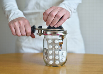 many pills and medicines in a glass jar