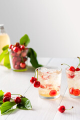 Refreshing summer sweet cherries drink, cocktail with ice and cherry