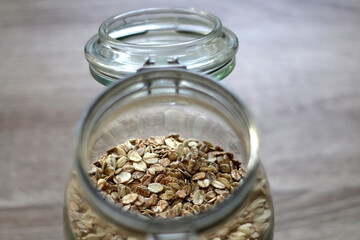 Glass jar with oats in the kitchen. Selective focus.