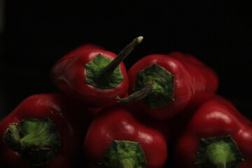 fresh organic peppers on a black background