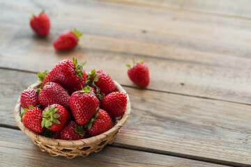 Fresh strawberries on basket top view. Healthy food on wooden table mockup. Delicious, sweet, juicy and ripe berry backgroung with copy space for text - Powered by Adobe