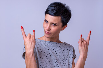 Attractive woman making a devil horns gesture