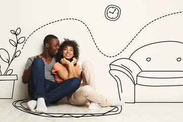 Black guy and his girlfriend imagining new furnished home against white wall with interior drawings