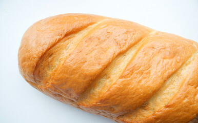 A loaf of fresh white bread, with a crust, on a light background. Bread texture, homemade cakes, cooking, breakfast, bakery. Product Rise