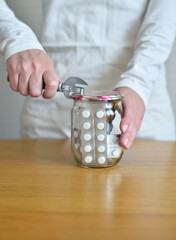 many pills and medicines in a glass jar