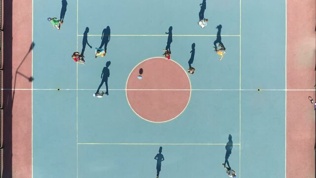 Aerial Top Down View of kids playing soccer. Special soccer field for children. Caring for children. Sports activities with children. Dynamic action in summer day. kidsn soccer team playing in the