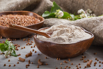 Rural still-life - the buckwheat flour and the peeled groats of buckwheat with blooming branch...