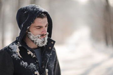 portrait of a hipster, a bearded young man in winter