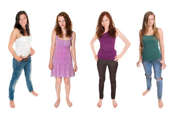 Fototapeta premium Full length portraits of four beautiful girls wearing casual summer clothes, isolated on white background