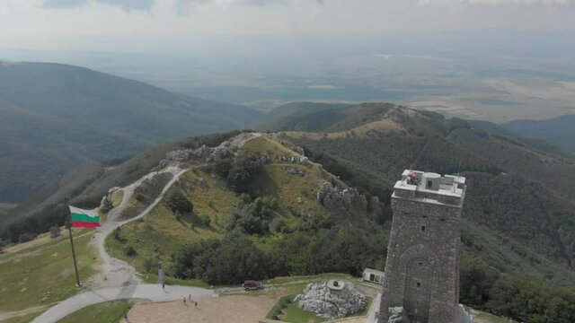 Historical Stone Tower Of Shipka Monument With Bulgarian Flag In Shipka Pass, Balkan Mountains In Bulgaria.  - aerial drone