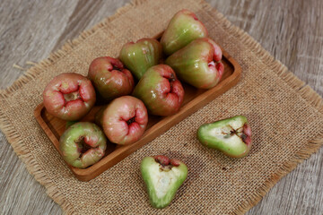Rose apple fruit in wooden tray