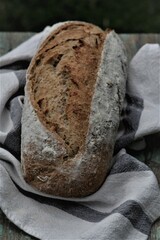 Homemade sourdough bread on authentic cloth .