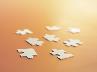 Close-up puzzles lying on an orange background. A concept of large wooden puzzles. Soft focus on the front puzzle. Order, Puzzle, Jigsaw Piece, Connection, Leisure Games. Jigsaw Puzzle pieces