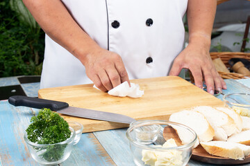Chef cleaning wooden broad with tissue paper