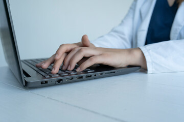 Doctor works at a computer, laptop
