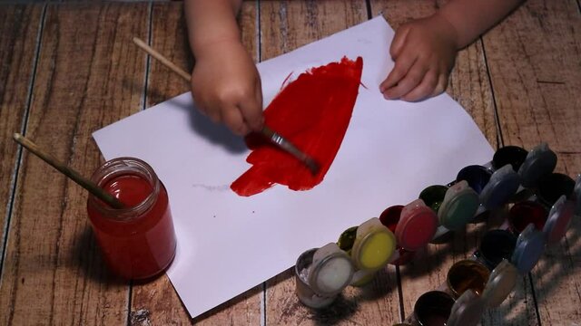 The Child Draws With Red Paint On Paper. Children's Creativity, Hanging Out At Home, Developing Children.