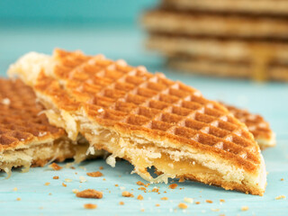 Stroopwafels or caramel Dutch Waffle close up on turquoise wooden background