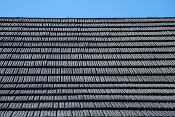 roof shingles on top of the house against blue sky, roof background
