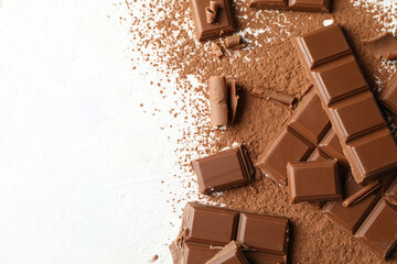 Tasty chocolate and powder on white background. Sweet food