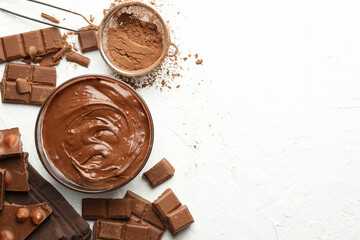 Chocolate, melted chocolate and powder on white background