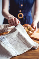 Homemade bread stored in a reusable linen bag with drawstring. Eco friendly Zero waste concept.