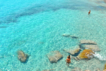  paradise clear turquoise blue water with rocks in Favignana island, Cala Azzura Beach, Sicily South Italy.