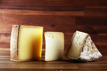 various types of organic cheese on rustic vintage table