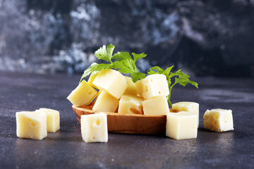cheese cubes on vintage table with parsley.