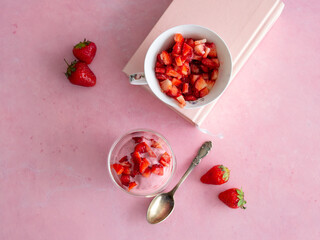 Strawberry ice cream in a glass cup on a pink background. Yogurt ice cream. Diet, healthy eating. Fresh strawberries. Copy space, close up.