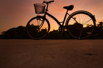 The silhouette image with Bicycle at sunset