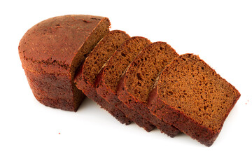 Loaf of sliced dark brown black bread isolated on white background.