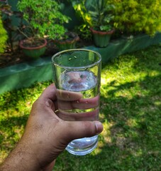 hand holding a glass of water