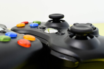 Two joysticks from the xbox console on a green background