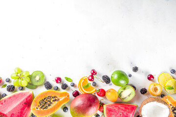Fototapeta na wymiar Assorted different summer tropical fresh raw fruits and berries. Clean eating, healthy lifestyle, diet and vitamin concept. 