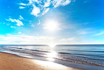 Morning seaside beach clam waves with blue sky background.