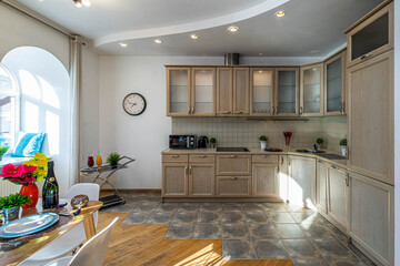 Modern interior of kitchen in spacious studio apartment. Private house. Stylish kitchen set with appliances.