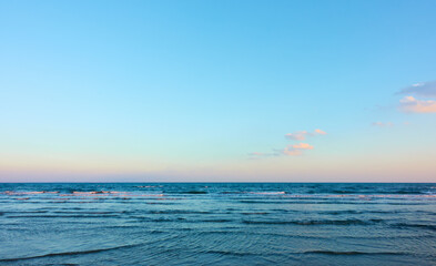 Fototapeta premium Sea with clear horizon and blue sky with clouds - background