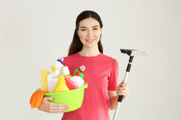 Young housewife is doing house cleaning.
