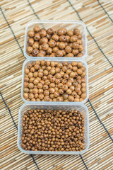 Wooden Beads and Buttons, Natural Craft Supplies, Colorful Sewing Thread on Bamboo Background