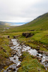 Little waterfall Klifbrekkufossar in Mjoifjordur, Iceland