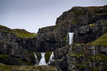 Fototapeta na wymiar Little waterfall Klifbrekkufossar in Mjoifjordur, Iceland