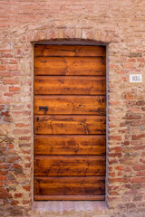 beautiful door in a street of old medieval village in Tuscany