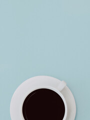 Black coffee Top view photo Close-up cup of black coffee is standing on a blue background