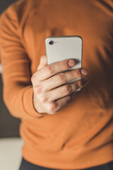 man using mobile phone with right hand