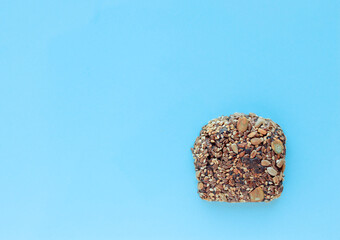 Sliced whole grain bread rye with seeds flax, sunflower, pumpkin and sesame.Healthy food, eco-friendly natural products. Fresh bread on a pink background.