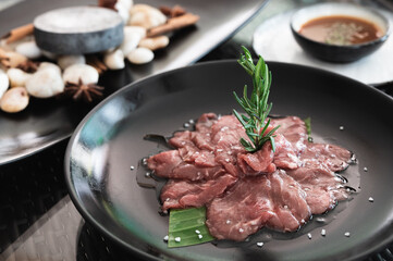 Sliced juicy raw lamb meat, cooking ingredient. preparing for grill on a hot rock.