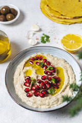 Close up of traditional arabic dip from baked eggplants with olive oil and pomegranate